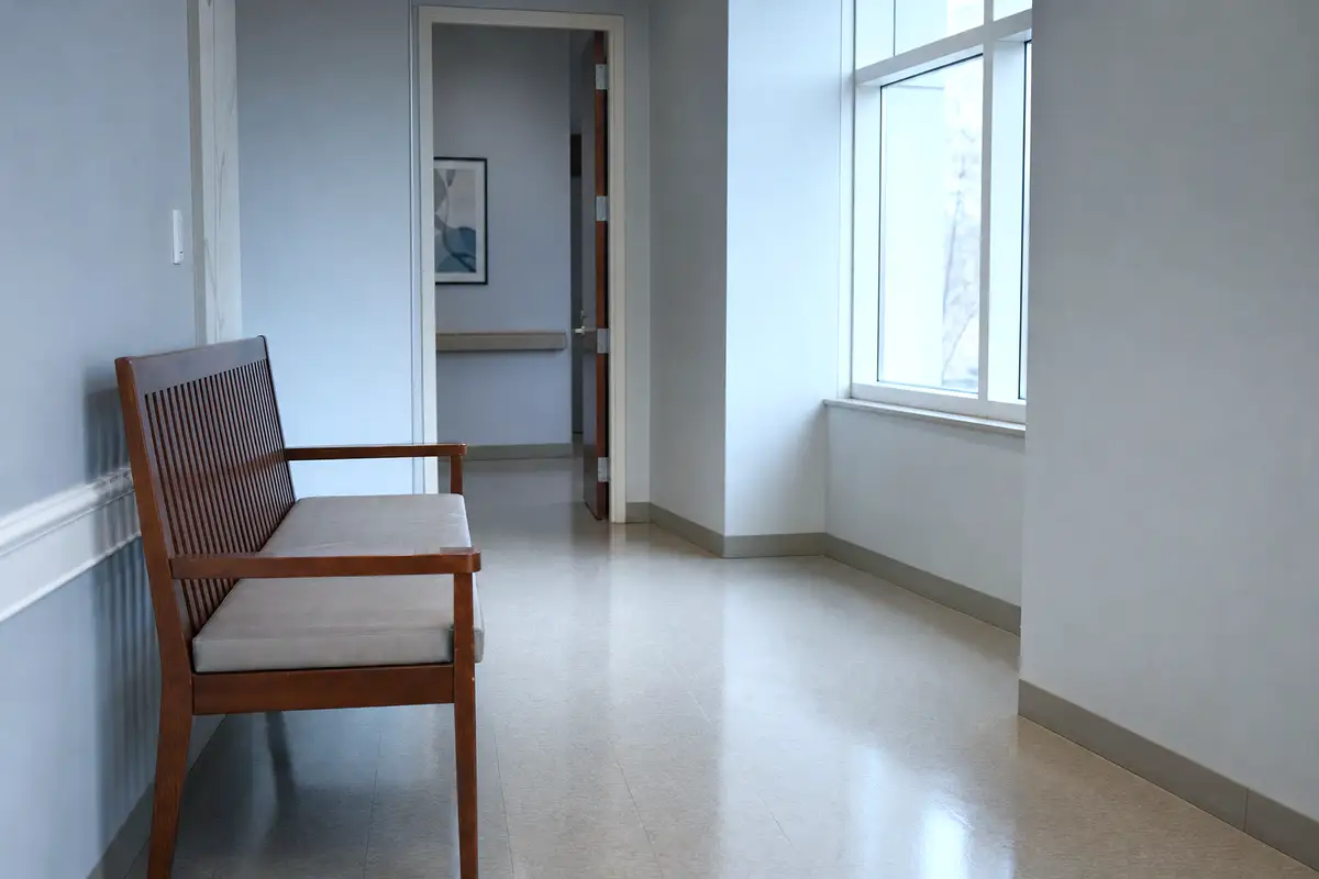 A quiet clinic bench in soft window light.