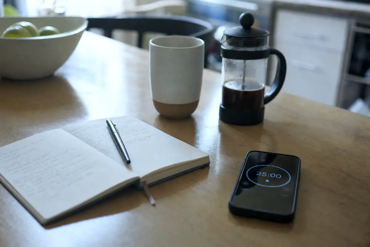 A notebook and a phone on a kitchen table, the kind of notes parents bring after a spell.