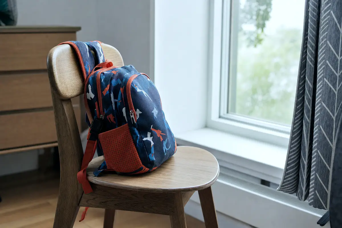 A backpack by a window, the sort of school morning headaches interrupt.